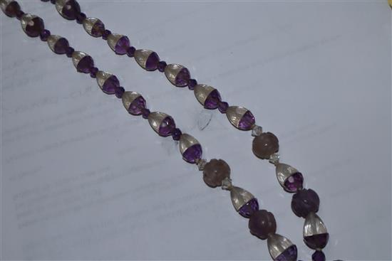 A Chinese amethyst and rock crystal pendant hung from a carved amethyst and rock crystal necklace, pendant 38mm.